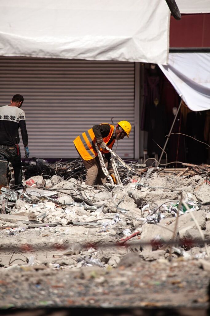 Mastering the First Impression: Your intriguing post title goes here Workers in reflective vests clear debris from earthquake damage in Malatya, Türkiye.