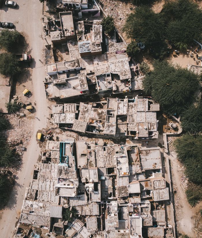 The Art of Drawing Readers In: Your attractive post title goes here Aerial shot of an abandoned town with clustered buildings and green trees.